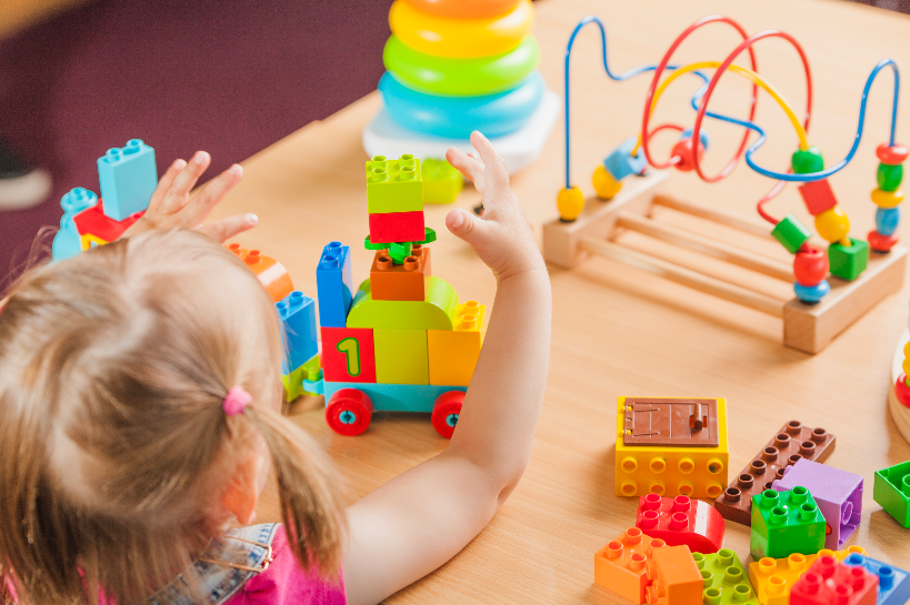 toddler girl sitting playing