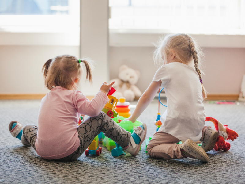 two-little-girls-sitting-floor-playing